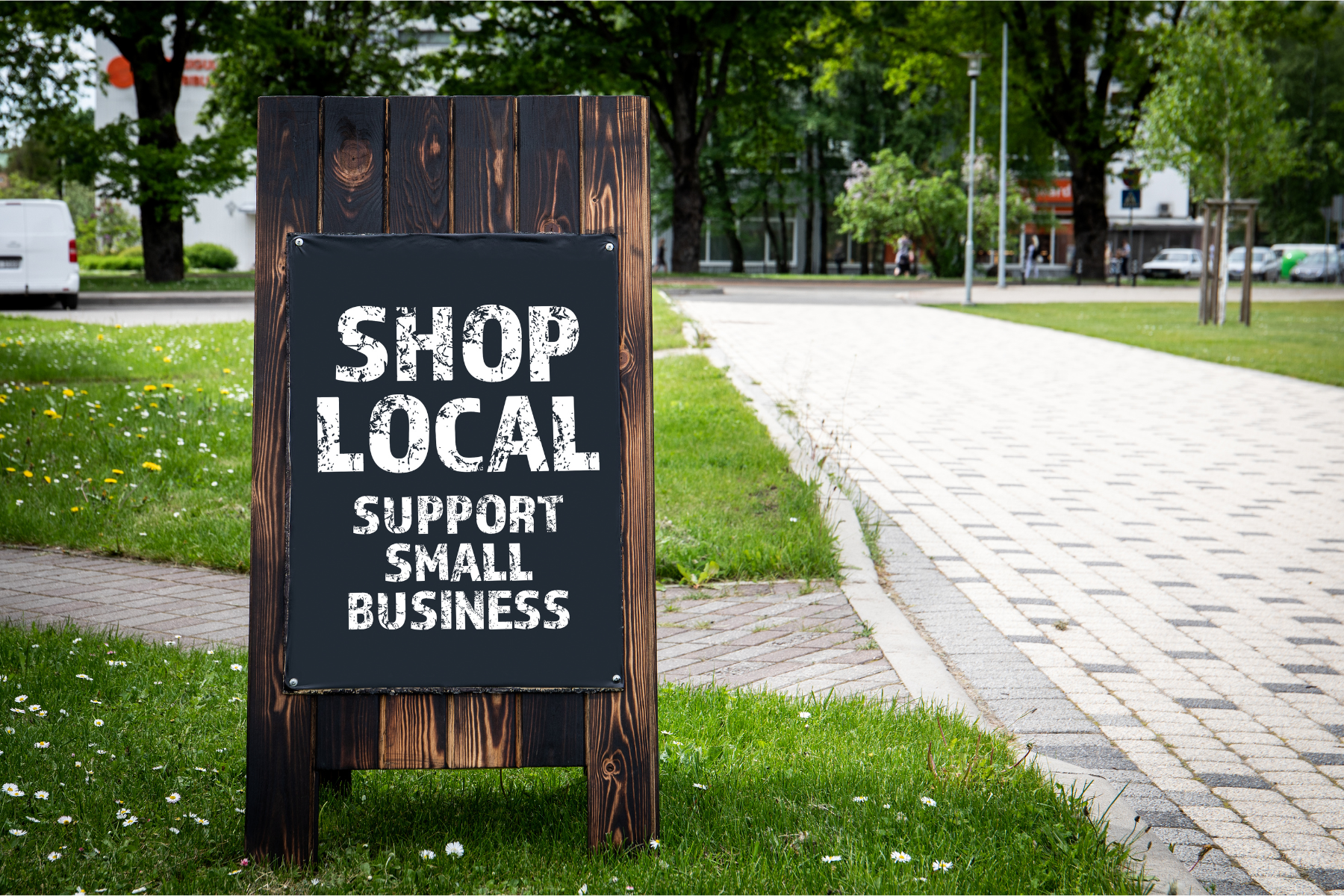 Photo of a sign that says "Shop Local Support Small Businesses"