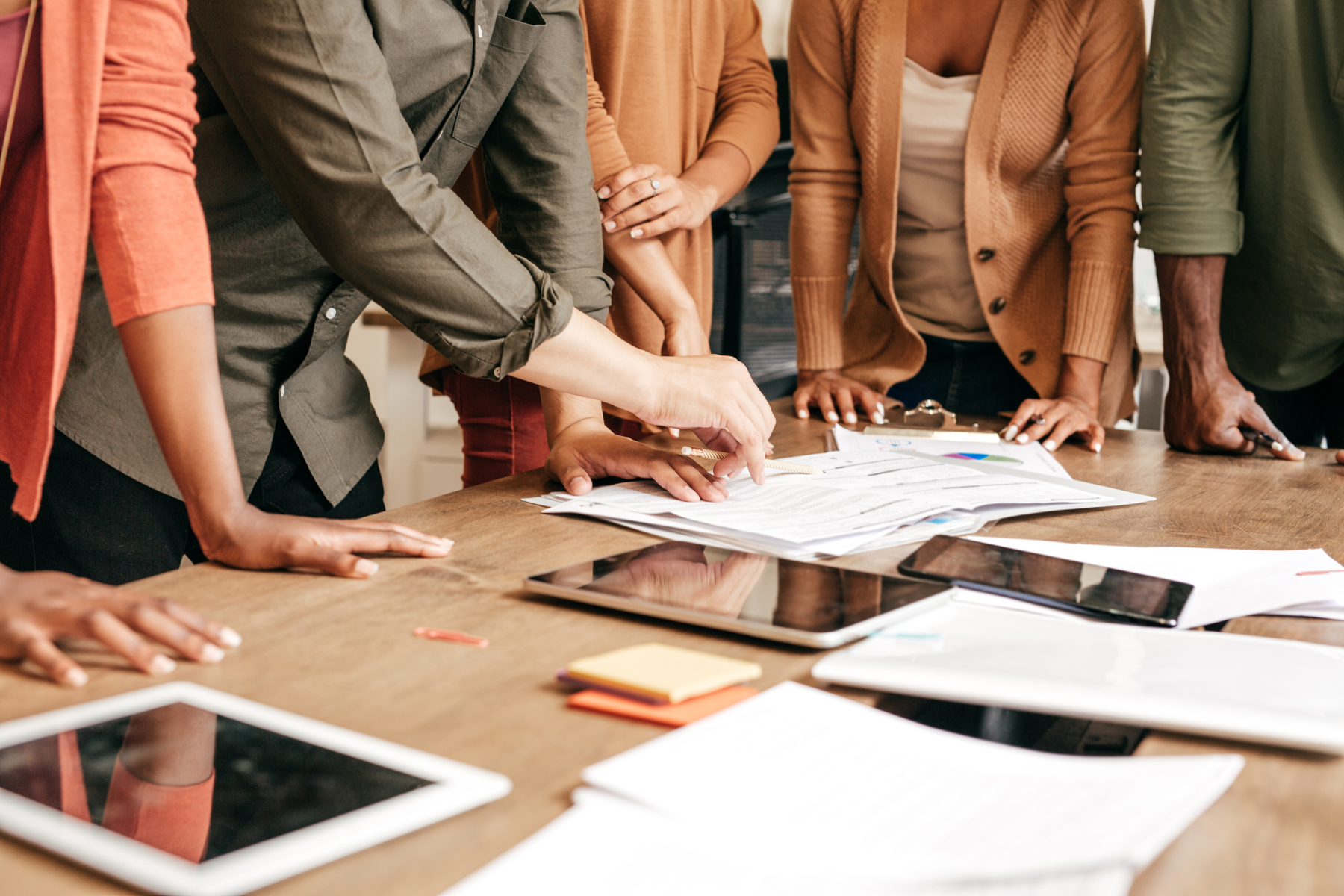 Photo of a group gathered around a desk with social media strategy papers
