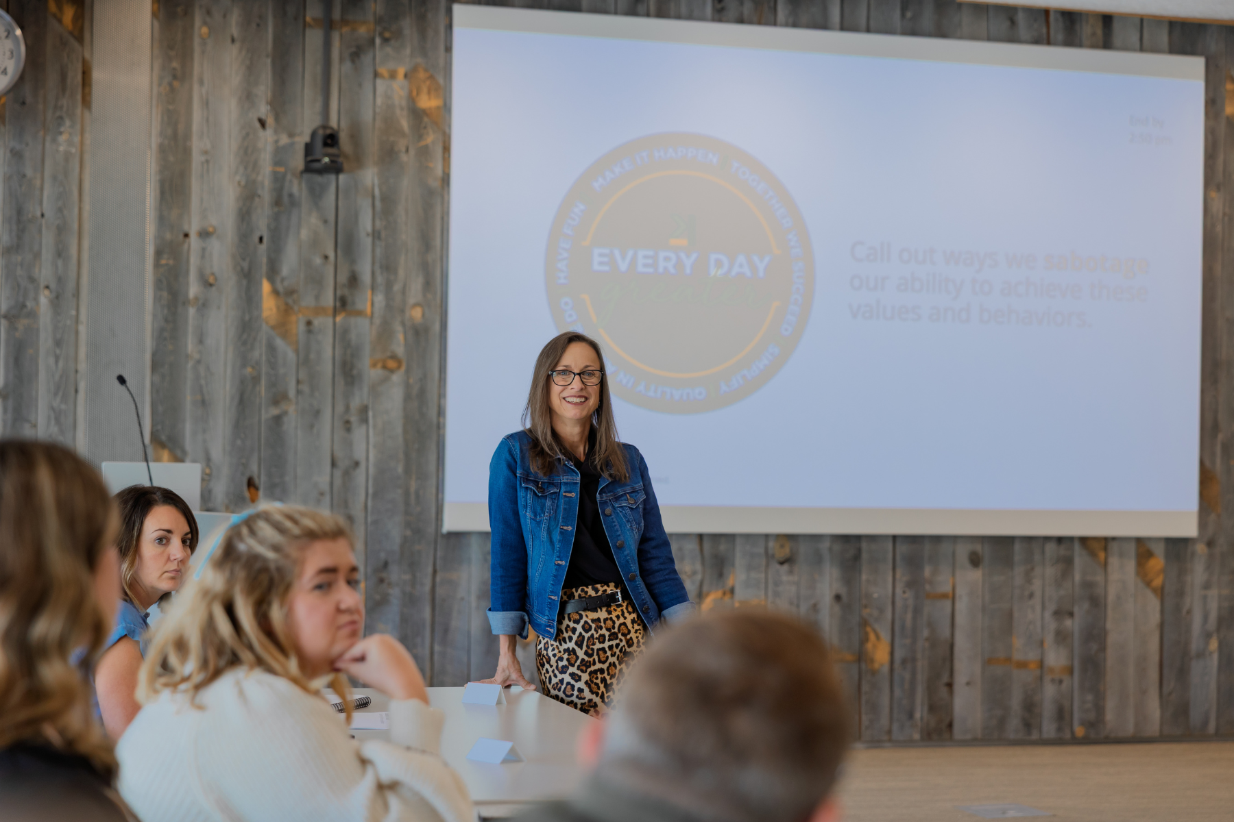 Photo of trainer standing in front of a presentation in a Kinetic meeting