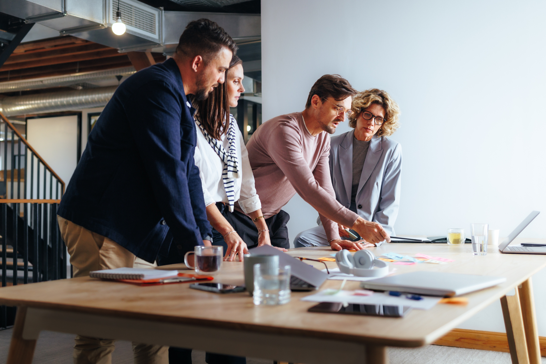Photo of a group gathered around a table strategizing