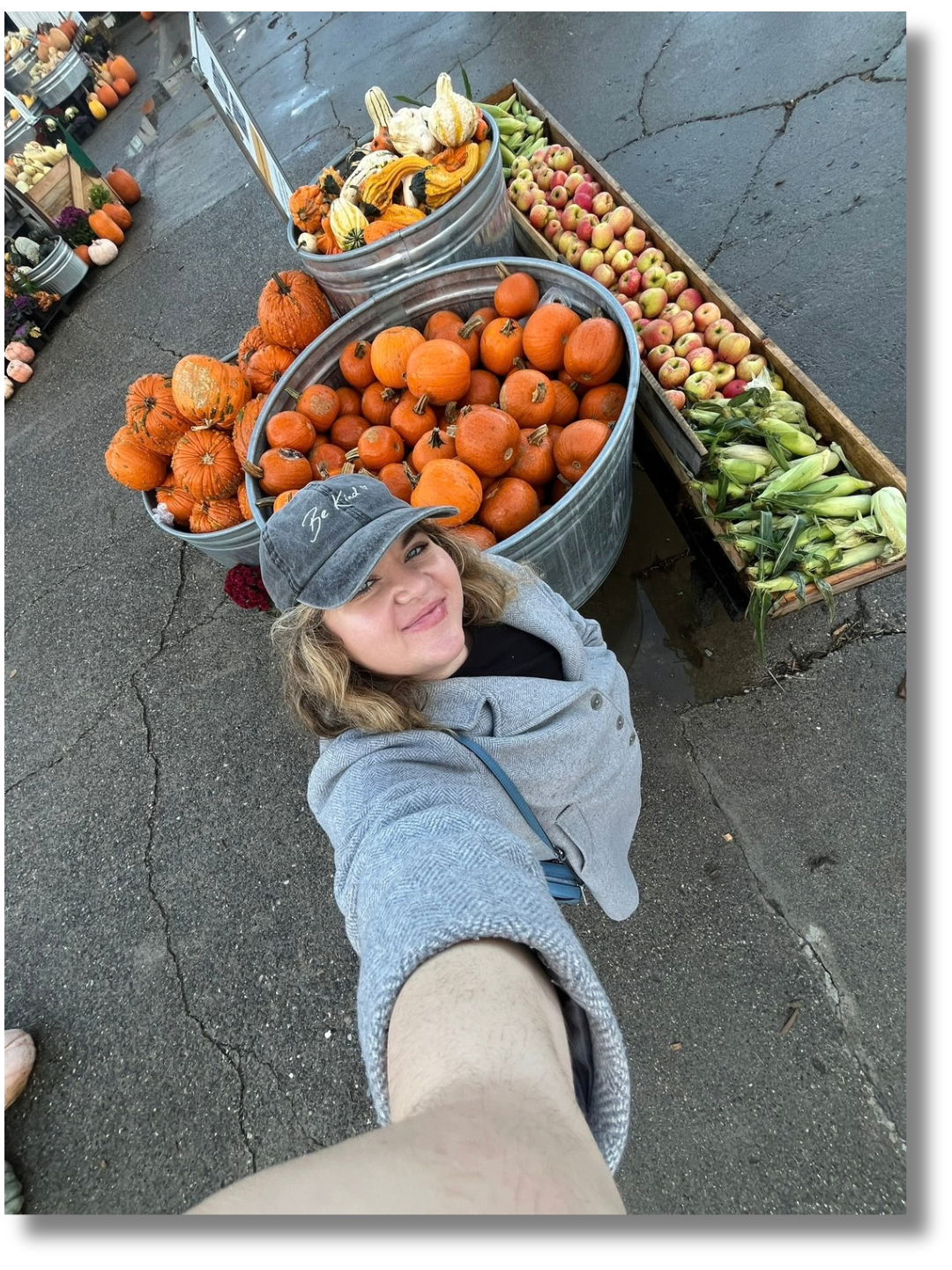 Kinetic Greenhouse team member taking a selfie with fall produce