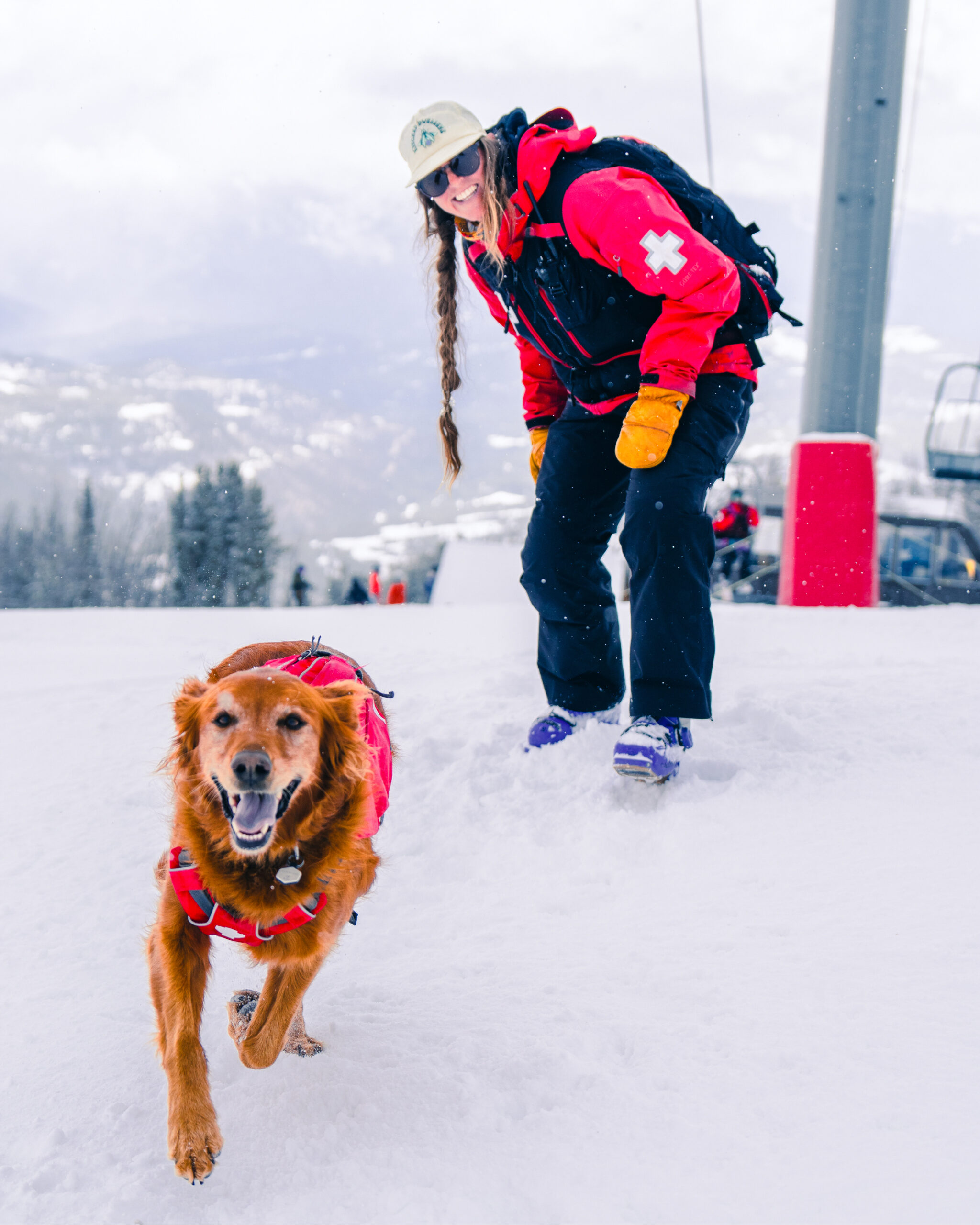 a woman and her puppy running through the snow 