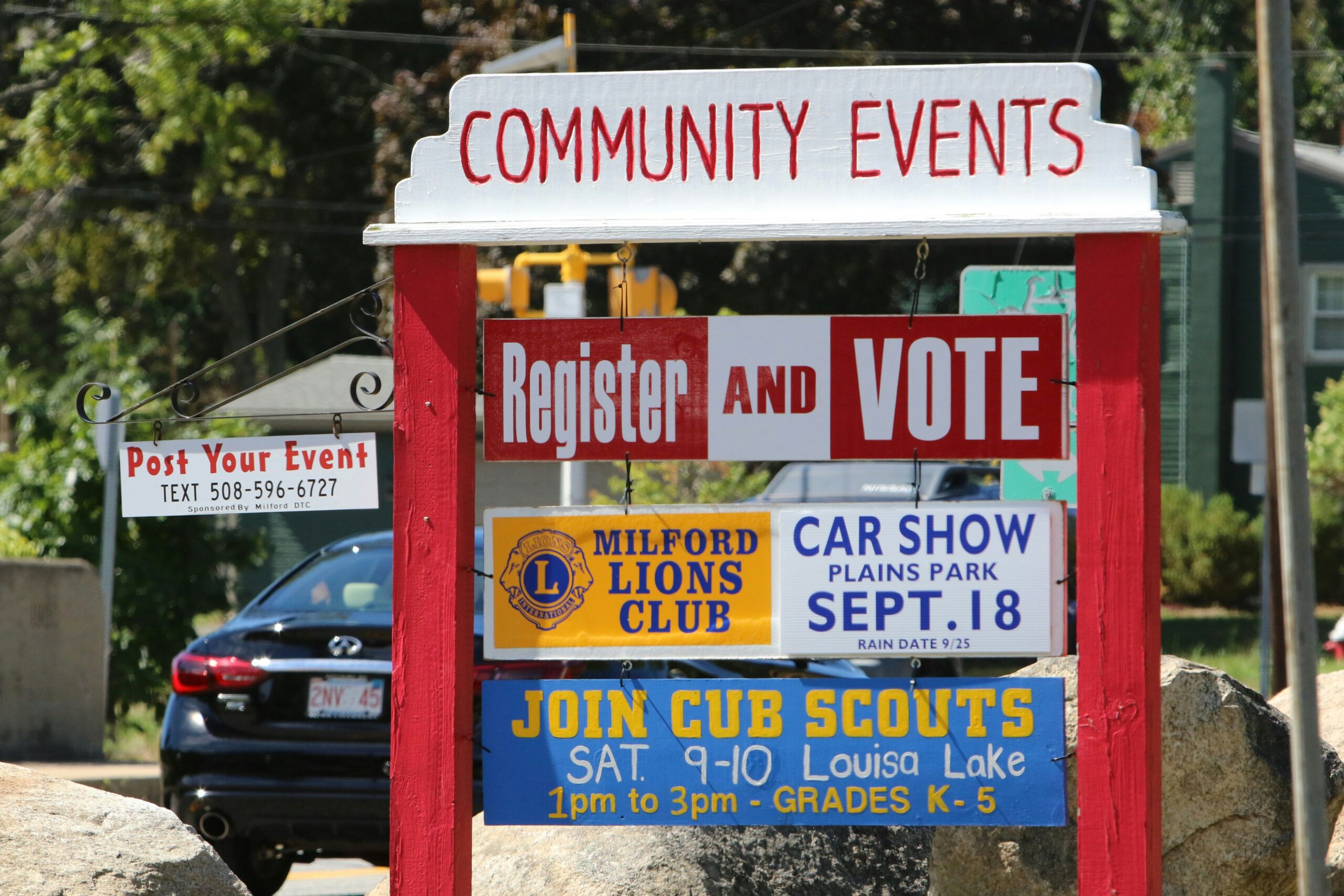 Photo of a community events board in a small town with upcoming events listed. 
